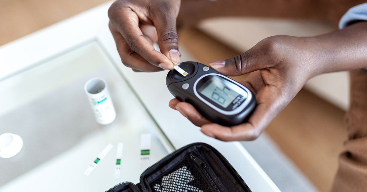 Nurse using blood sugar tester